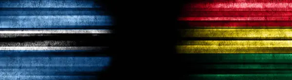 黒い背景にボツワナとボリビアの旗 — ストック写真