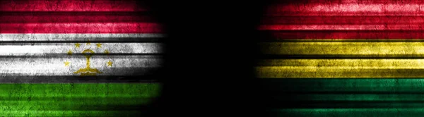 Tadschikistan Und Bolivien Flaggen Auf Schwarzem Hintergrund — Stockfoto