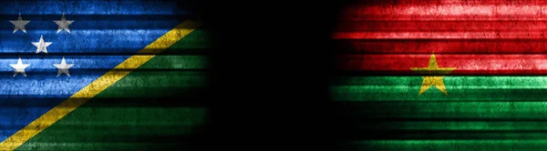 Solomon Islands and Burkina Faso Flags on Black Background