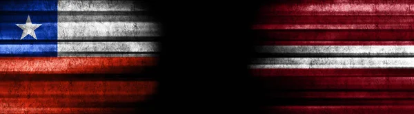 智利和拉脱维亚黑色背景旗 — 图库照片