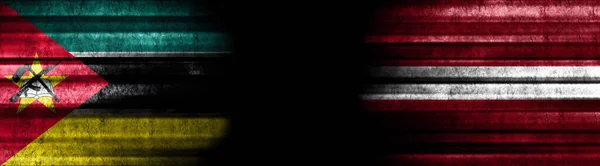 Banderas Mozambique Letonia Sobre Fondo Negro —  Fotos de Stock