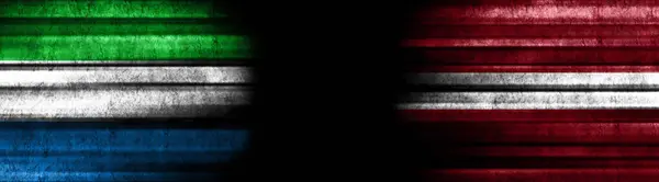 Sierra Leone and Latvia Flags on Black Background