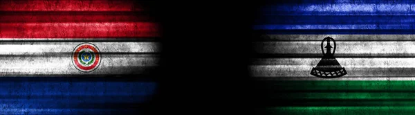 巴拉圭和莱索托黑色背景旗 — 图库照片