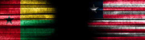 ギニアビサウとリベリアの黒い背景の旗 — ストック写真