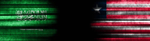 サウジアラビアとリベリアの黒い背景の旗 — ストック写真