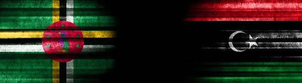 Dominica Und Libyen Flaggen Auf Schwarzem Hintergrund — Stockfoto
