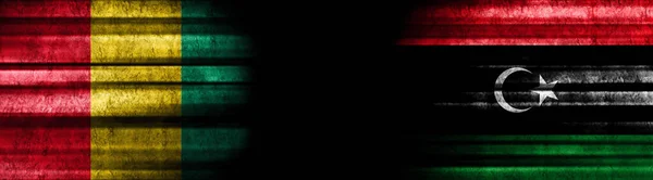 几内亚和利比亚黑色背景旗 — 图库照片