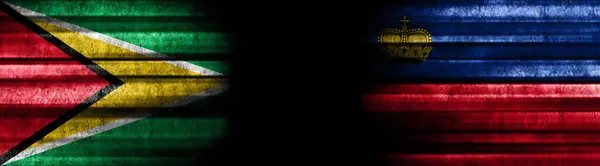 黒い背景のガイアナとリヒテンシュタインの旗 — ストック写真