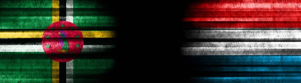 ブラックバックグラウンドのドミニカとルクセンブルクの旗 — ストック写真