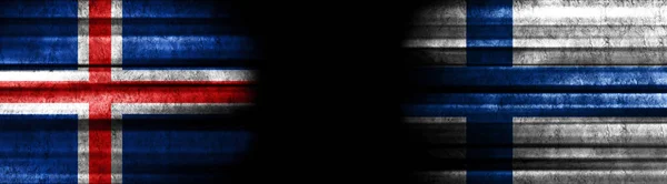 黒い背景にアイスランドとフィンランドの旗 — ストック写真