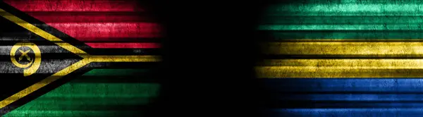 ブラックバックグラウンドのバヌアツとガボンの旗 — ストック写真