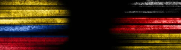コロンビアとドイツ 黒い背景の旗 — ストック写真