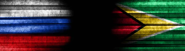 俄罗斯和圭亚那黑色背景旗 — 图库照片