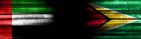 阿拉伯联合酋长国和圭亚那关于黑人背景的旗帜 — 图库照片