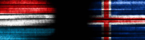 ブラックバックグラウンドのルクセンブルクとアイスランドの旗 — ストック写真