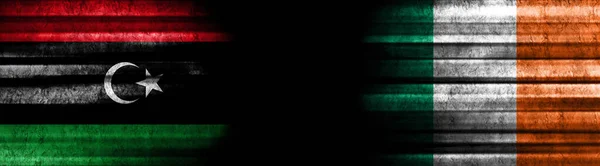 Libya and Ireland Flags on Black Background