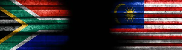 South Africa and Malaysia Flags on Black Background