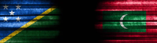 Solomon Islands and Maldives Flags on Black Background