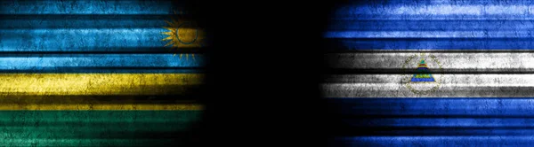 Rwanda Nicaragua Flags Black Background — Stock Photo, Image
