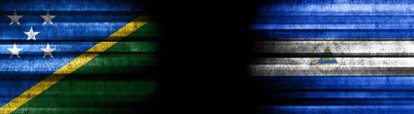 Solomon Islands and Nicaragua Flags on Black Background