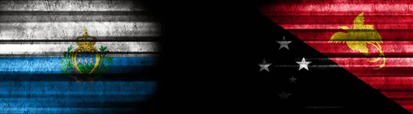 San Marino Papua New Guinea Flags Black Background — Stock Photo, Image
