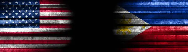 United States and Philippines Flags on Black Background