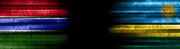 冈比亚和卢旺达黑色背景旗帜 — 图库照片