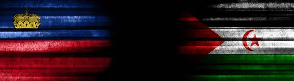 リヒテンシュタインとサハラウィア 黒い背景の民主共和国旗 — ストック写真