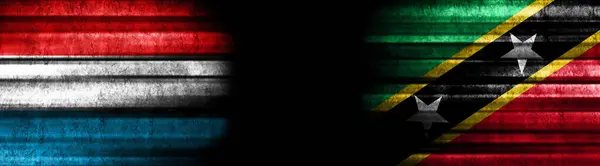 ブラックバックグラウンドのルクセンブルクとセントキッツとネイビスの旗 — ストック写真