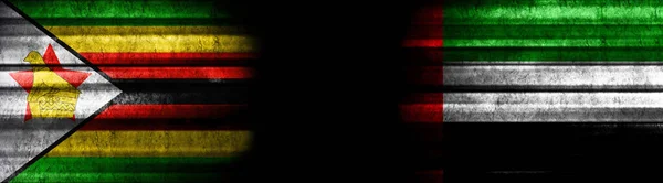 ジンバブエとアラブ首長国連邦 黒い背景の旗 — ストック写真