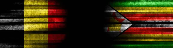 ブラックバックグラウンドのベルギーとジンバブエの旗 — ストック写真