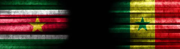 苏里南和塞内加尔黑色背景旗帜 — 图库照片