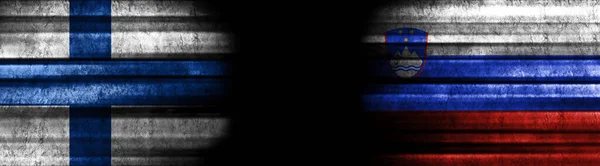 Finland and Slovenia Flags on Black Background