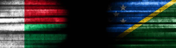 Madagascar and Solomon Islands Flags on Black Background
