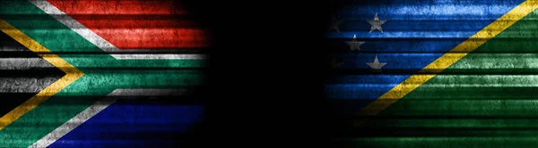 South Africa and Solomon Islands Flags on Black Background