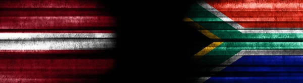 Banderas Letonia Sudáfrica Sobre Fondo Negro —  Fotos de Stock