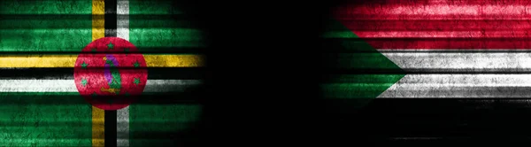 Dominica Und Sudan Flaggen Auf Schwarzem Hintergrund — Stockfoto