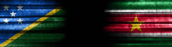 Solomon Islands and Suriname Flags on Black Background