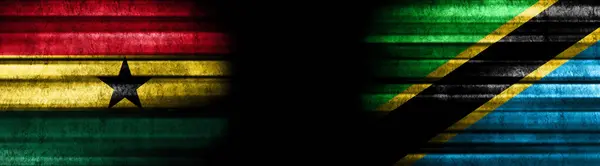 黒い背景にガーナとタンザニアの旗 — ストック写真