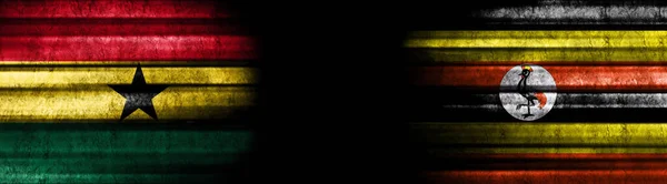 ガーナとウガンダの旗 黒い背景 — ストック写真