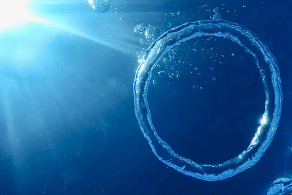 stock image Underwater Bubble Ring Ascends towards the Sun