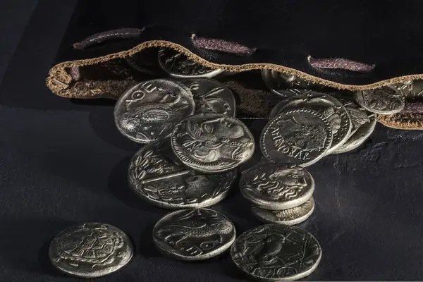 stock image Leather pouch full of ancient silver coins treasure hoard