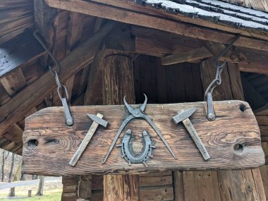 the open-air museum of traditional wooden architecture in the national park in Ukraine, tools view on wooden wall 