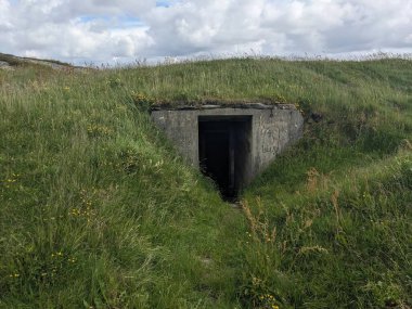Çimlerde terk edilmiş eski askeri sığınak..
