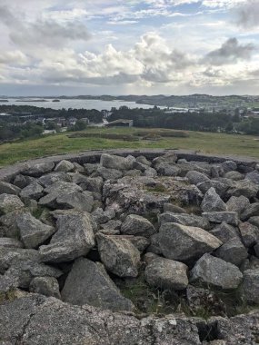 Şehir ve nehir manzarası bir tepeden taş yığınıyla