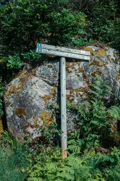 stock image Wooden signpost in mountain landscape with rock formations, Trollpikken, Egersund in Norway, Europe