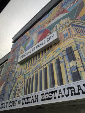 Mural showcasing vibrant colors at the Indian restaurant in a bustling urban neighborhood during late afternoon clipart