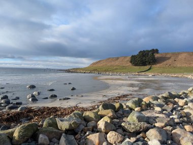 Stormy atmosphere over coastal stone beach