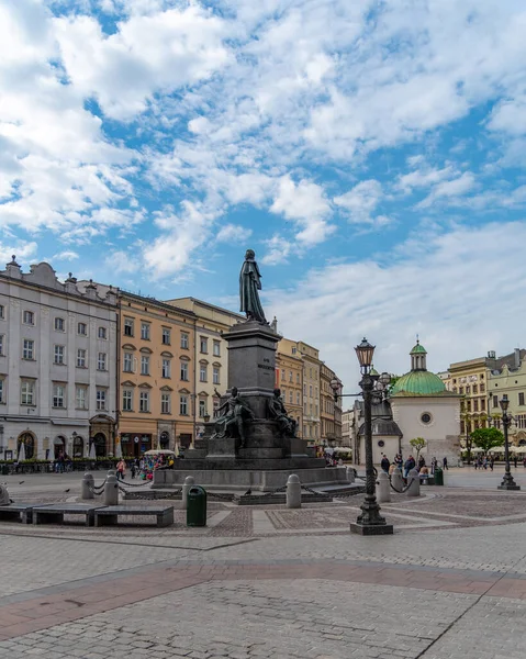 stock image Krakow, Lesser Poland / Poland - 05/11/2019. Adam Mickiewicz Monument in the Main Market Square is very popular during the day with tourists.