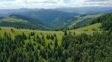 Güneşli bir yaz gününde bir dağ geçidinin tepesinde yürüyen insanların insansız hava aracı görüntüleri..